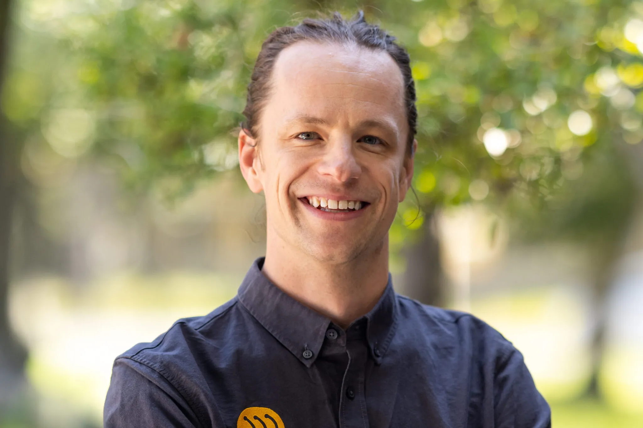 Market research analyst at Mayfield Renewables smiling in professional outdoor headshot