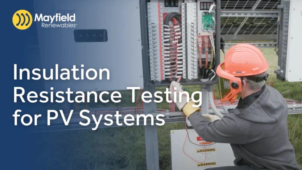 Technician performing insulation resistance testing on PV system electrical equipment