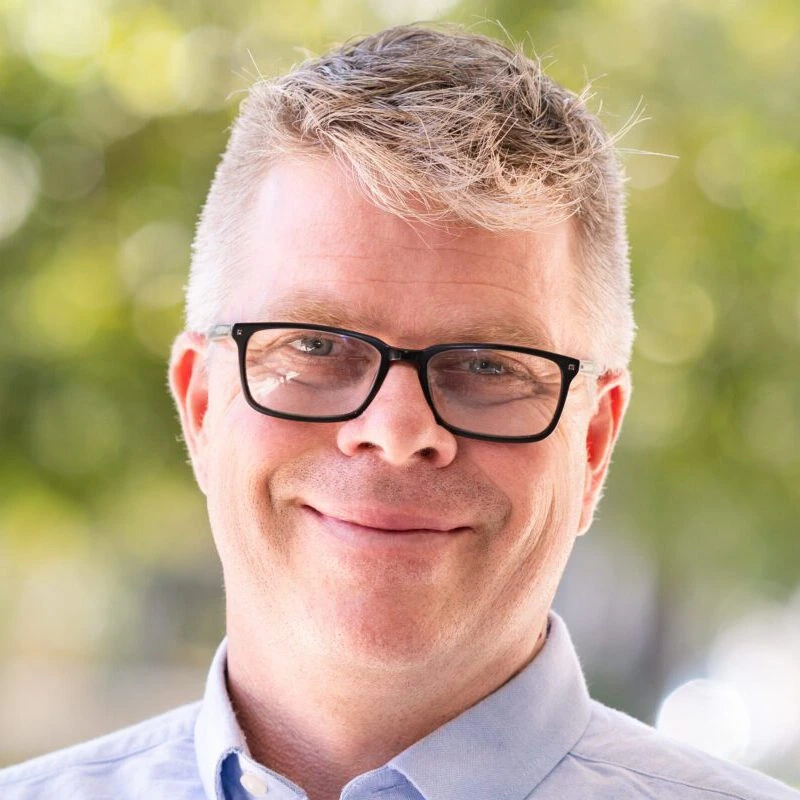 Founder of Mayfield Renewables smiling in professional outdoor headshot
